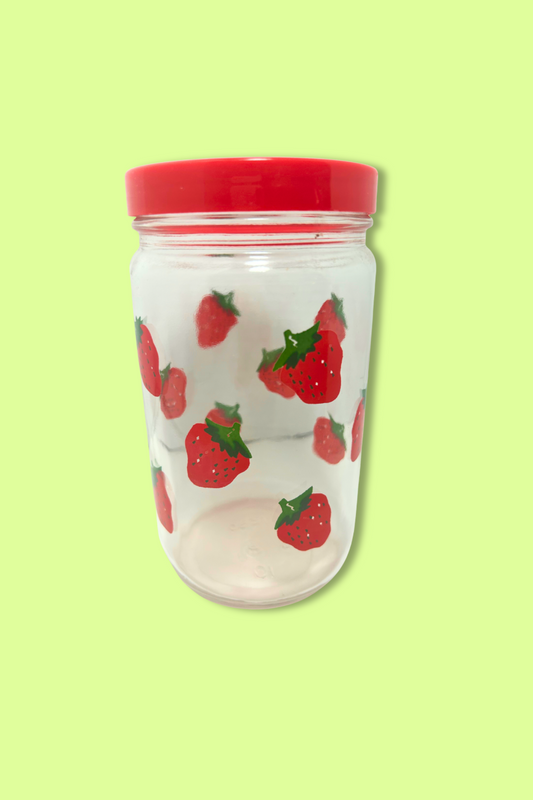 Jar with strawberry pattern and red lid on a light green background
