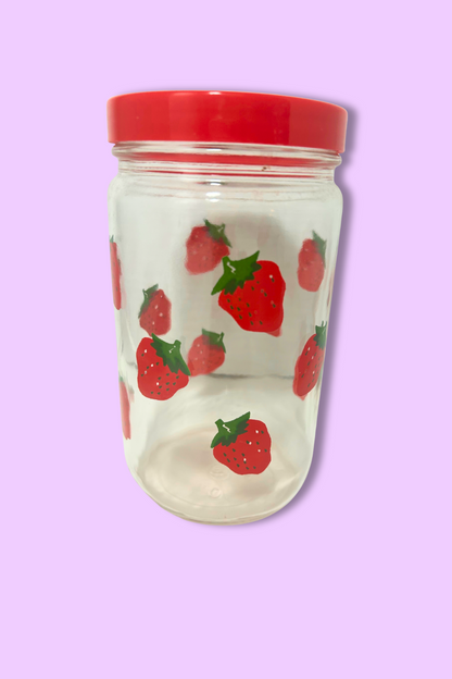 Clear tumbler with red lid featuring strawberry pattern on a purple background