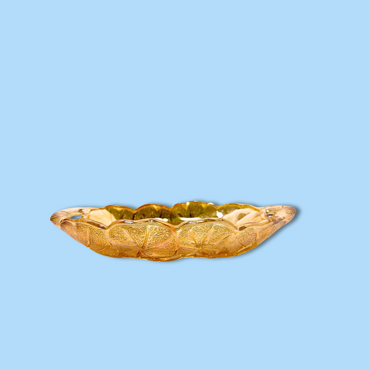 A vintage marigold Indiana carnival glass relish dish against a blue background.