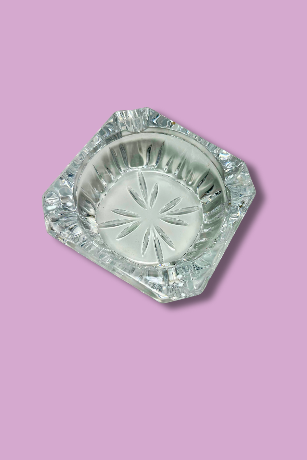 Crystal ashtray with star design on a pink background