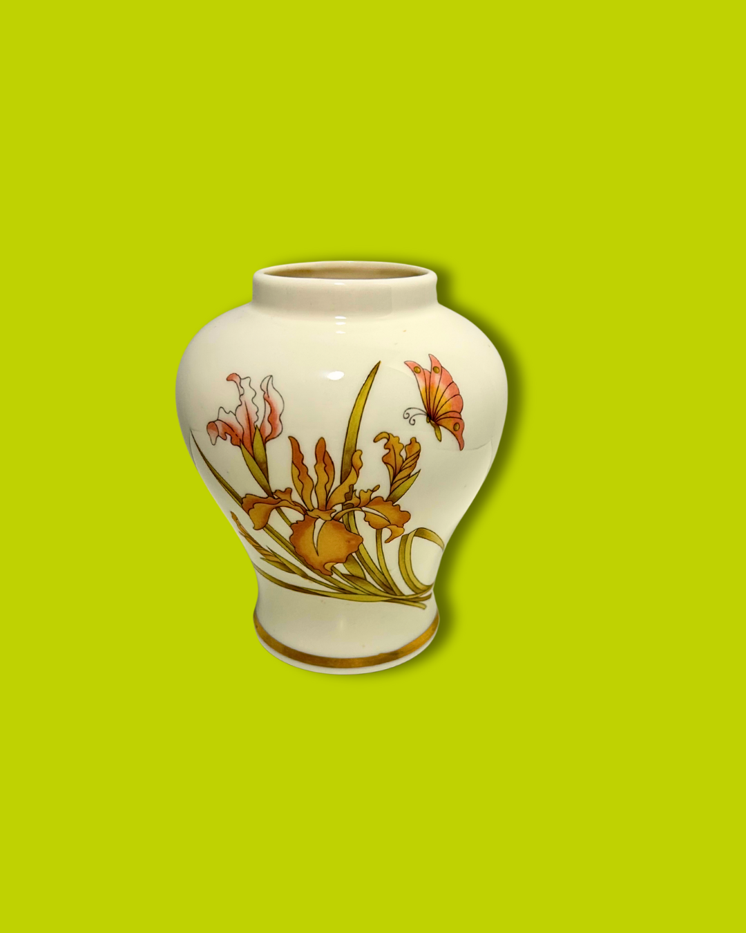 Ceramic vase with floral design on a green background