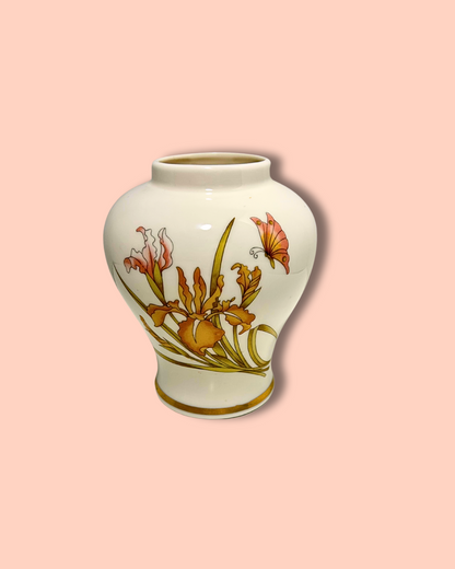 Decorative vase with floral design on a pink background