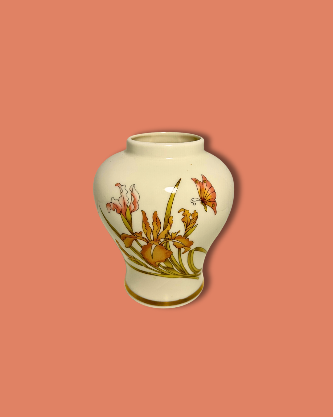 Decorative vase with floral design on a peach background