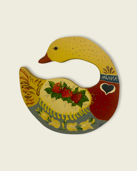 Decorative duck-shaped plate with strawberry design on a beige background
