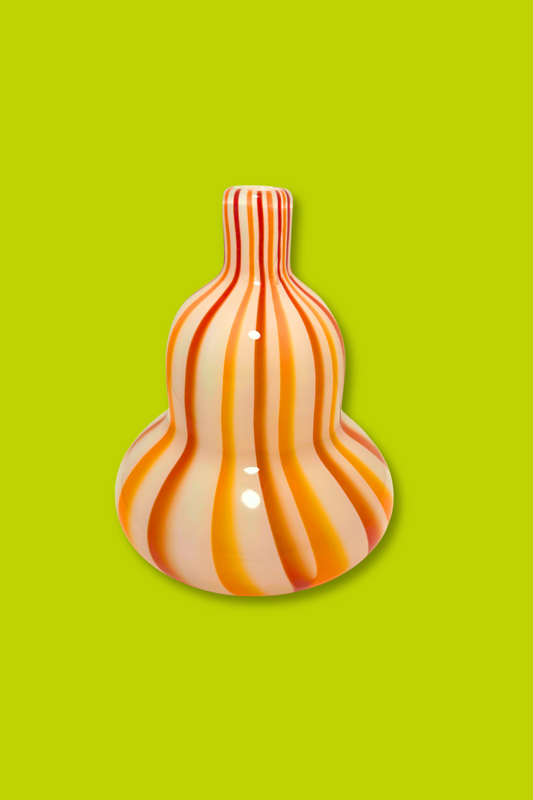 Decorative vase with wavy pattern on a green background