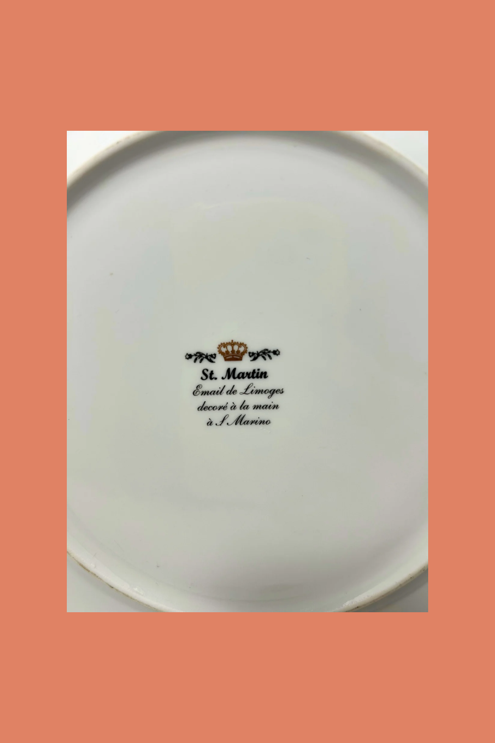 White plate with black text and logo on a peach background