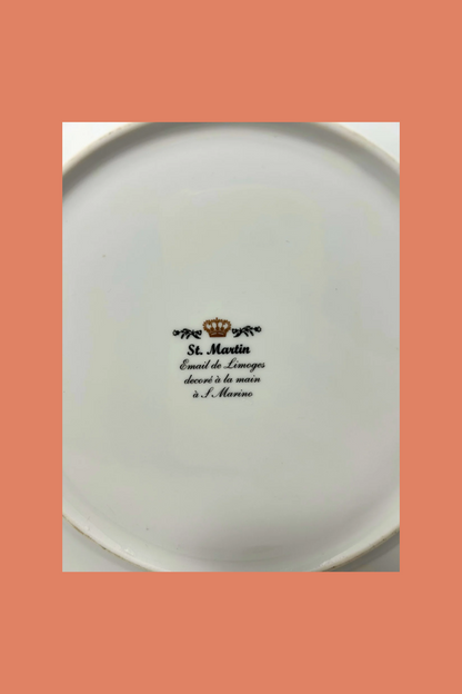 White plate with black text and logo on a peach background