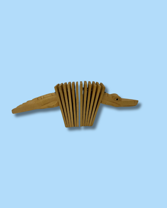 Wooden duck-shaped instrument on a light blue background